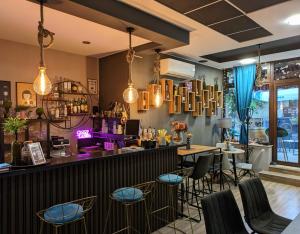 a bar in a restaurant with chairs and tables at Hotel La Roka in Stara Zagora