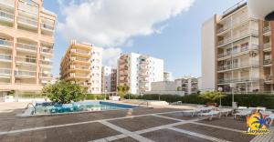a swimming pool in the middle of some apartment buildings at Center IBERPLAYA in Salou