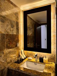 a bathroom with a sink and a large mirror at The Room Hotel - Starbucks in Phú Quốc +64 photos