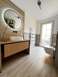 a bathroom with a sink and a large mirror at Posthaus Kloster Zinna in Jüterbog