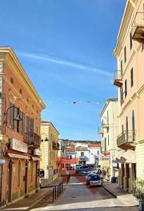 a city street with buildings and cars parked on the street at Daria in Santa Teresa Gallura