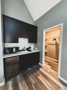 a kitchen with black cabinets and a counter top at Woodland Retreat at Tudor suites in Eureka Springs