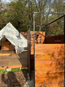 a wooden deck with a tent on top of it at Glamping nad vinicemi - kousek od Brna in Viničné Šumice