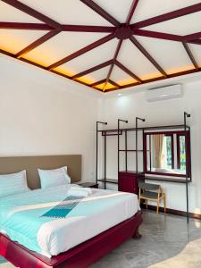 Postel nebo postele na pokoji v ubytování Nakasang Paradise Hotel