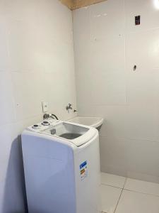 a small white bathroom with a sink and a toilet at Casa de praia Duplex com Piscina Flecheiras in Trairi +16 photos