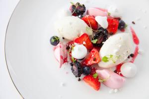 a plate of food with fruit and ice cream at The Petersham in Richmond upon Thames