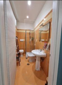 a bathroom with a sink and a toilet at Home Santa Chiara Marigliano in Marigliano