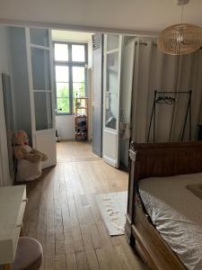 a bedroom with a bed and a teddy bear in it at Maison typique Bordeaux avec piscine in Bègles +19 photos
