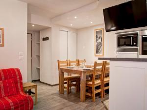 a kitchen and dining room with a table and chairs at Appartement Centre-Ville avec Terrasse à Brides-les-Bains, Proche Télécabine et Spa - FR-1-512-138 in Brides-les-Bains +12 photos