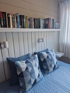 ein Schlafzimmer mit einem Bett mit blauen und weißen Kissen in der Unterkunft Storehorn Apartments Hemsedal in Fausko + 10 Fotos