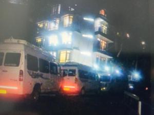a bus parked in front of a building at night at Green Mountain View Himachal Pradesh With Restaurant in Shimla