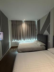 Winn's Hotel Bentong客房内的一张或多张床位