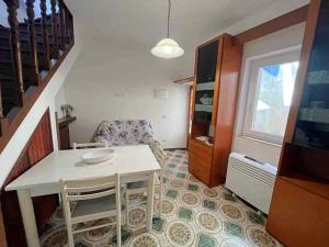 a small living room with a table and a chair at Ammiraglio Giglio Castello in Isola del Giglio +18 photos