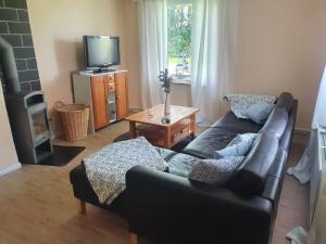 a living room with a couch and a tv at Kalles kuschelige Koje in Krummendeich