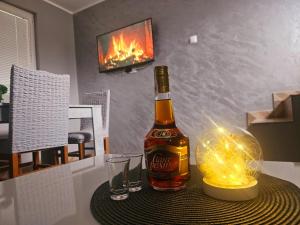 a bottle of beer and two glasses on a table at Drinski sjaj in Ljubovija +21 photos