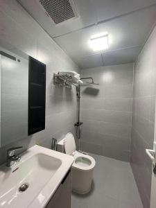 a bathroom with a white toilet and a sink at Nhà Shi Homestay in Hue