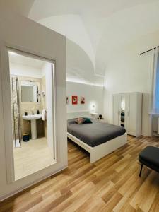 a bedroom with a bed and a sink and a mirror at Svolta Boutique in Lecce