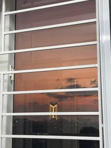 a window with a reflection of a building in it at Nhà Shi Homestay in Hue +6 photos
