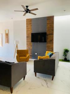 a living room with two couches and a tv at Casa Residencia de Renta en Country Club, San Carlos Sonora in El Caballito