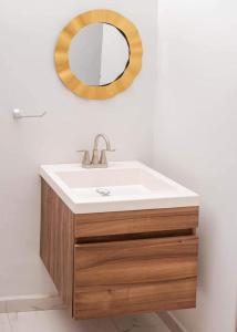 a bathroom with a sink and a mirror at Casa Residencia de Renta en Country Club, San Carlos Sonora in El Caballito