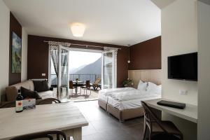 ein Schlafzimmer mit einem Bett und ein Wohnzimmer in der Unterkunft Residence Usignolo in Trarego