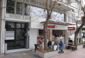a store front with people walking outside of it at Oreades Parthenon Suites in Athens
