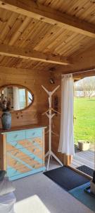 a wooden cabin with a wooden ceiling and a dresser at Agnes Bed and Breakfast in Bække