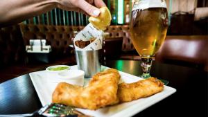 a plate of food and a glass of beer at Hilton Dubai The Walk in Dubai