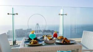 a table with plates of food on top of a balcony at Hilton Dubai The Walk in Dubai