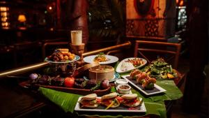 a table with several plates of food on it at Hilton Dubai The Walk in Dubai