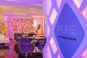 a room with purple chairs and tables and a purple sign at Hilton Dubai The Walk in Dubai