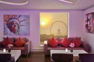 a living room with a couch and red pillows at Hilton Dubai The Walk in Dubai