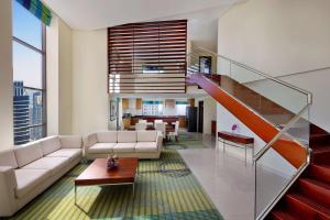 a living room with a couch and a staircase at Hilton Dubai The Walk in Dubai