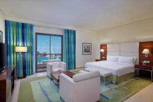 a hotel room with a bed and a large window at Hilton Dubai The Walk in Dubai
