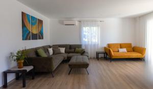 a living room with a couch and two chairs at Villa Kortus Luxury modern villa near Petram Resort, beach 700m and Adriatic golf resort in Savudrija