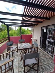 a patio with wooden tables and chairs on a roof at La casa de Yoni in Las Toninas +3 photos