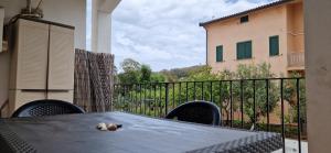 a teddy bear laying on a table on a balcony at Arbatax Apartment in Àrbatax