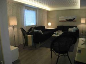 a living room with a dog laying on a couch at Villa Rusinlahti, private beach in Pieksamaki