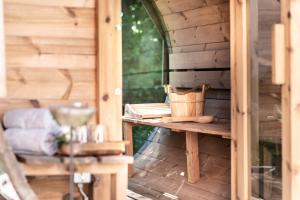 a wooden cabin with a table and a chair at Exklusives Design Hideaway & Sauna in Warngau