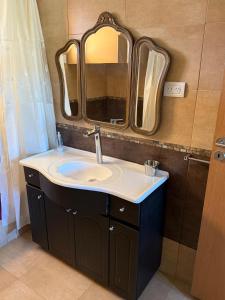 a bathroom with a sink and a large mirror at La Puerta de Cachi in Cachí +68 photos