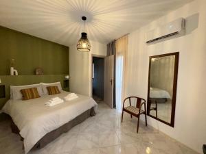 a bedroom with a bed and a mirror and a chair at Don Nicuzzo in Salemi