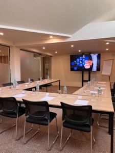 a conference room with tables and chairs and a flat screen tv at La Posada del Puente in Arequipa