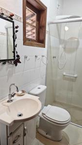 une salle de bain avec toilettes, lavabo et douche dans l'établissement Casa da Vila, Charme e Conforto no Coração de Visconde de Mauá, à Visconde de Mauá
