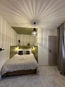 a bedroom with a large bed and a chandelier at Don Nicuzzo in Salemi +14 photos
