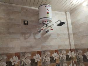 a robot hanging on the wall of a room at Golden Bar And Hotel in Sandīla