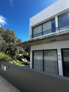 a white house with a fence in front of it at Bordal Houses Casa da Areia in Porto Santo