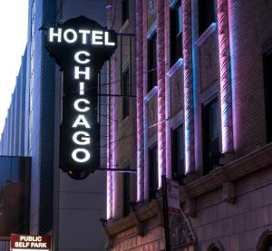 a neon sign hanging from the side of a building at Hotel Chicago West Loop in Chicago