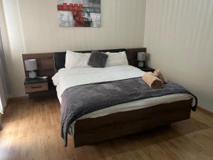 a bedroom with a large bed with two night stands at Résidence Eden in Kenitra