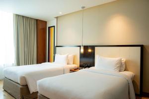 DoubleTree by Hilton-Pune Chinchwad客房内的一张或多张床位