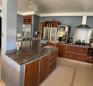 a kitchen with wooden cabinets and a counter top at casa Salta in Salta
